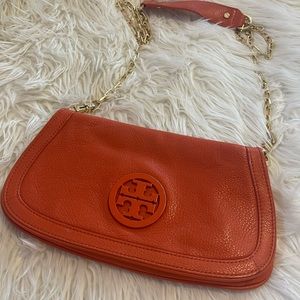 Orange colored cross body bag from Tory Burch.